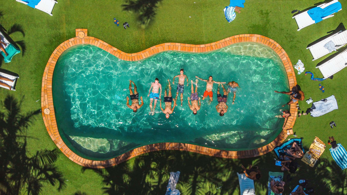 Drone view of Budds in Surfers pool with swimming backpackers