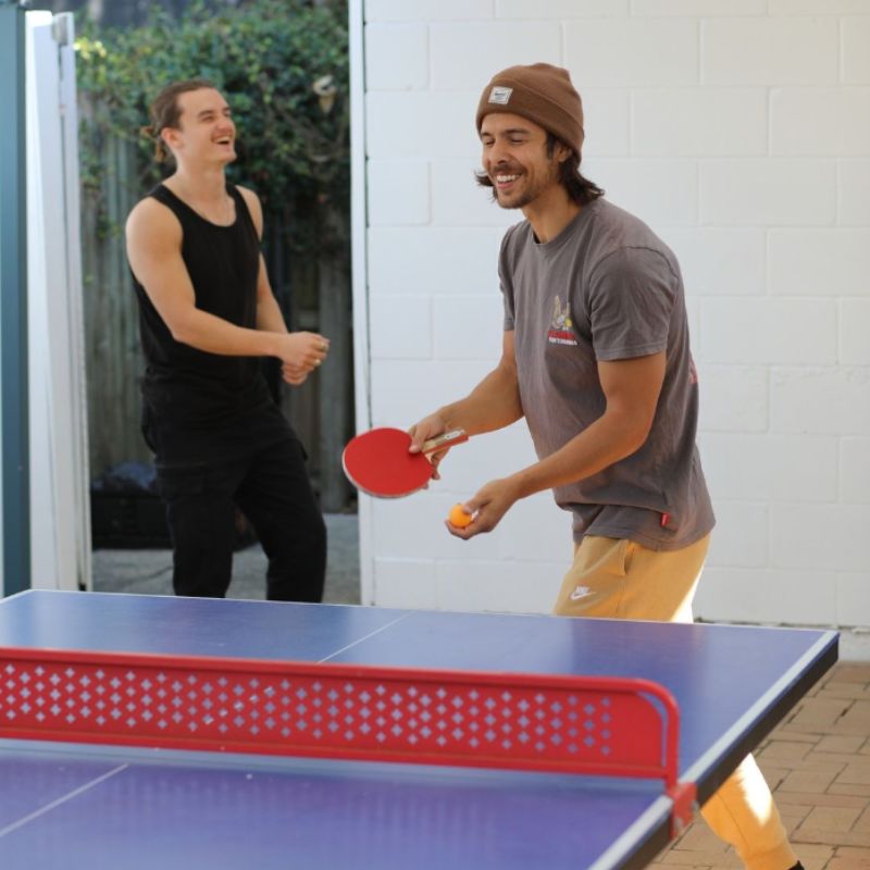 Budds hostel guests playing ping pong / table tennis