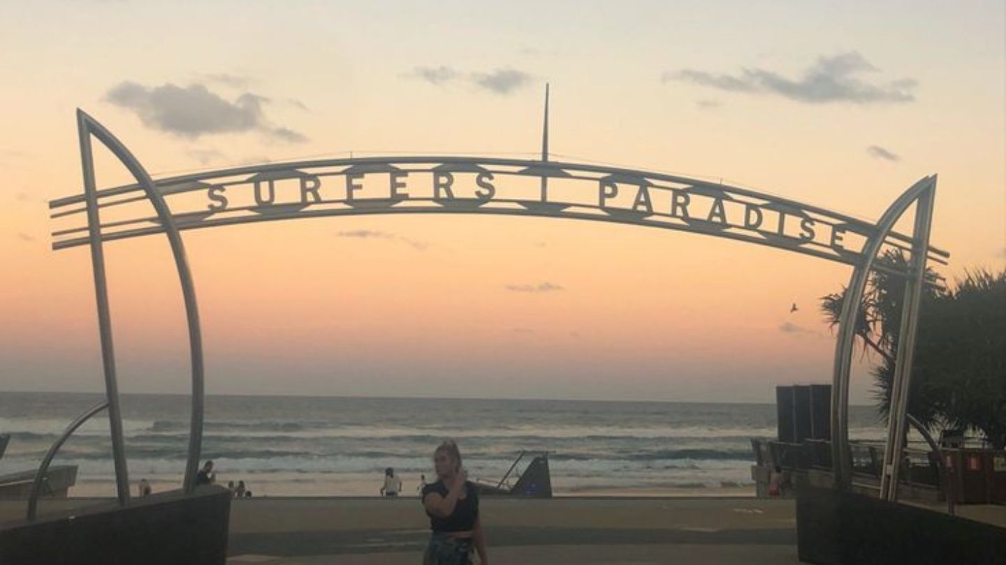 Surfers Paradise sign over the beach at sunset