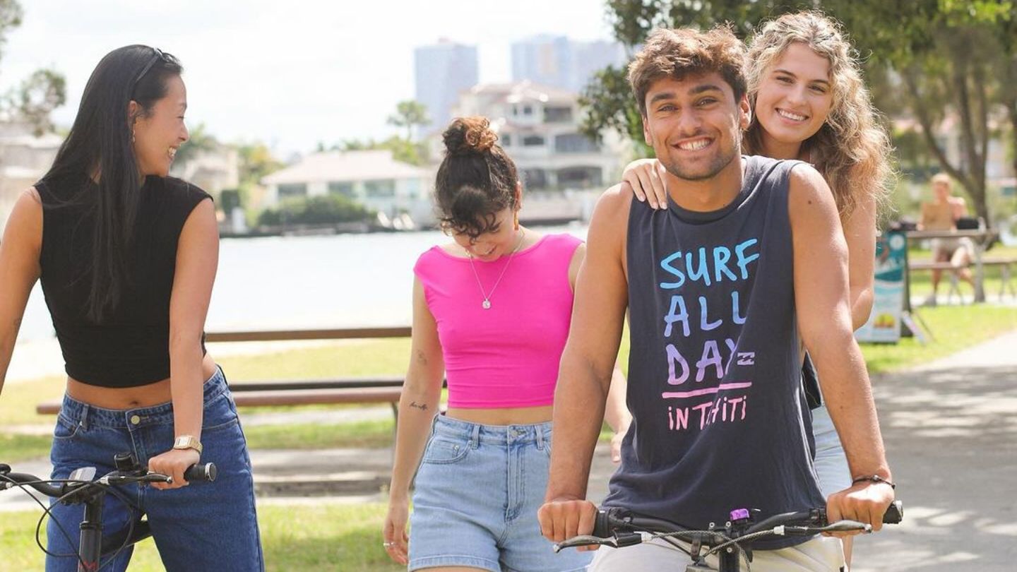 Budds hostel guests riding bikes along Budds Beach Gold Coast foreshore