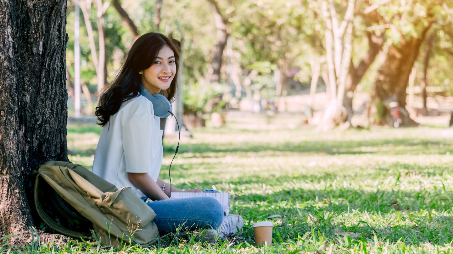 Backpacker relaxing under a tree in nature