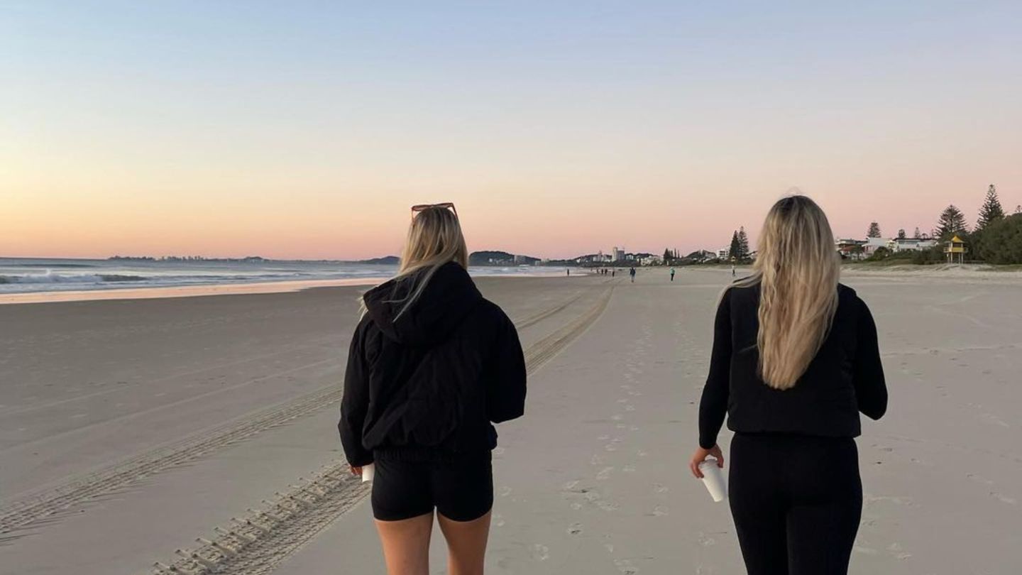 Two bacpackers enjoying a quite sunset walk along Main Beach, Gold Coast
