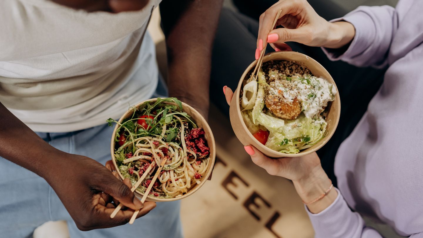 Hostel guests with bowl of healthy noodles