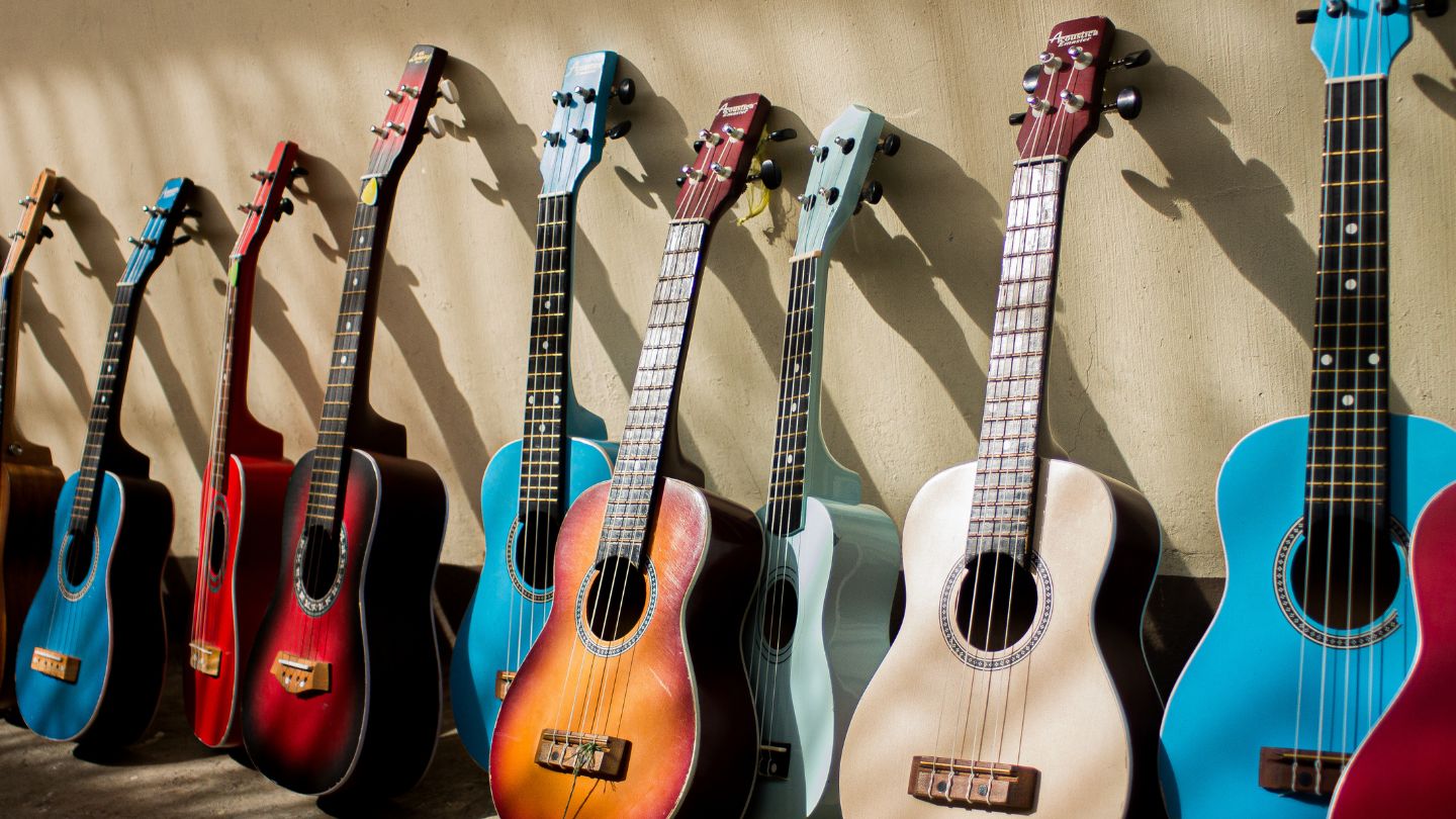 Row of acoustic guitars leaning against the wall